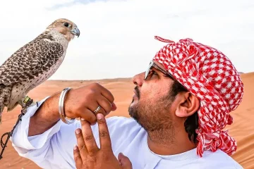Man with Falcon in Arabian Desert