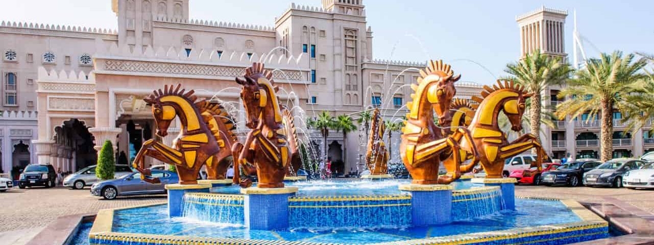Jumeirah Al Qasr Hotel Dubai, surrounded by lush gardens, waterways, and luxurious amenities