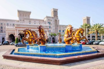 Jumeirah Al Qasr Hotel Dubai, surrounded by lush gardens, waterways, and luxurious amenities