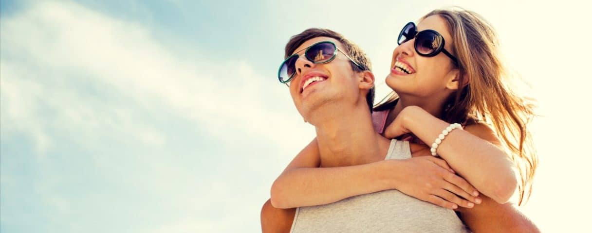 A joyful and romantic moment where a man lifts his partner in his arms
