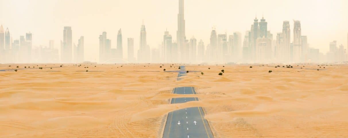 sand dunes with Dubai Skyline