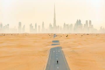 sand dunes with Dubai Skyline